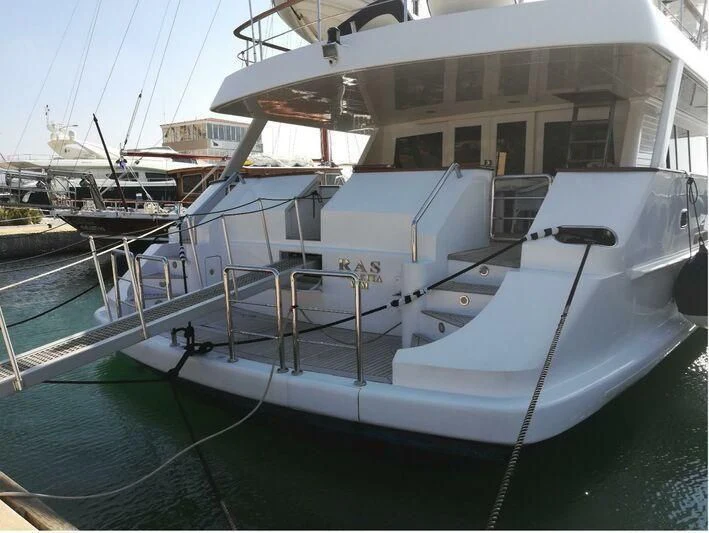 a boat docked at a pier aboard RAS Yacht for Sale