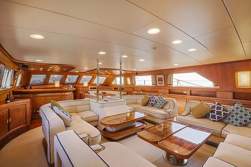 a living room with a large wood shelf and a wood coffee table aboard INFINIUM Yacht for Sale