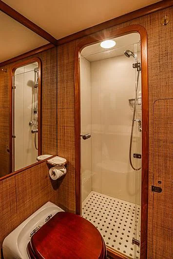 a bathroom with a shower and a toilet aboard INFINIUM Yacht for Sale