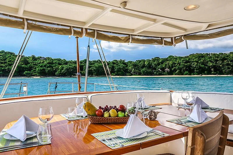 a table with fruits and glasses on it aboard INFINIUM Yacht for Sale