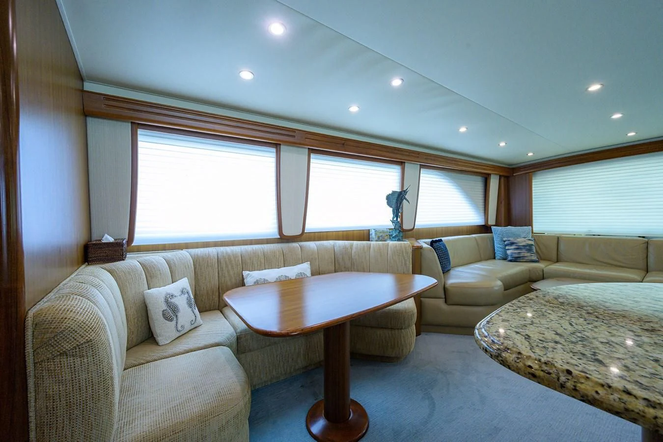 a living room with a couch and a table aboard RITE ANGLER Yacht for Sale