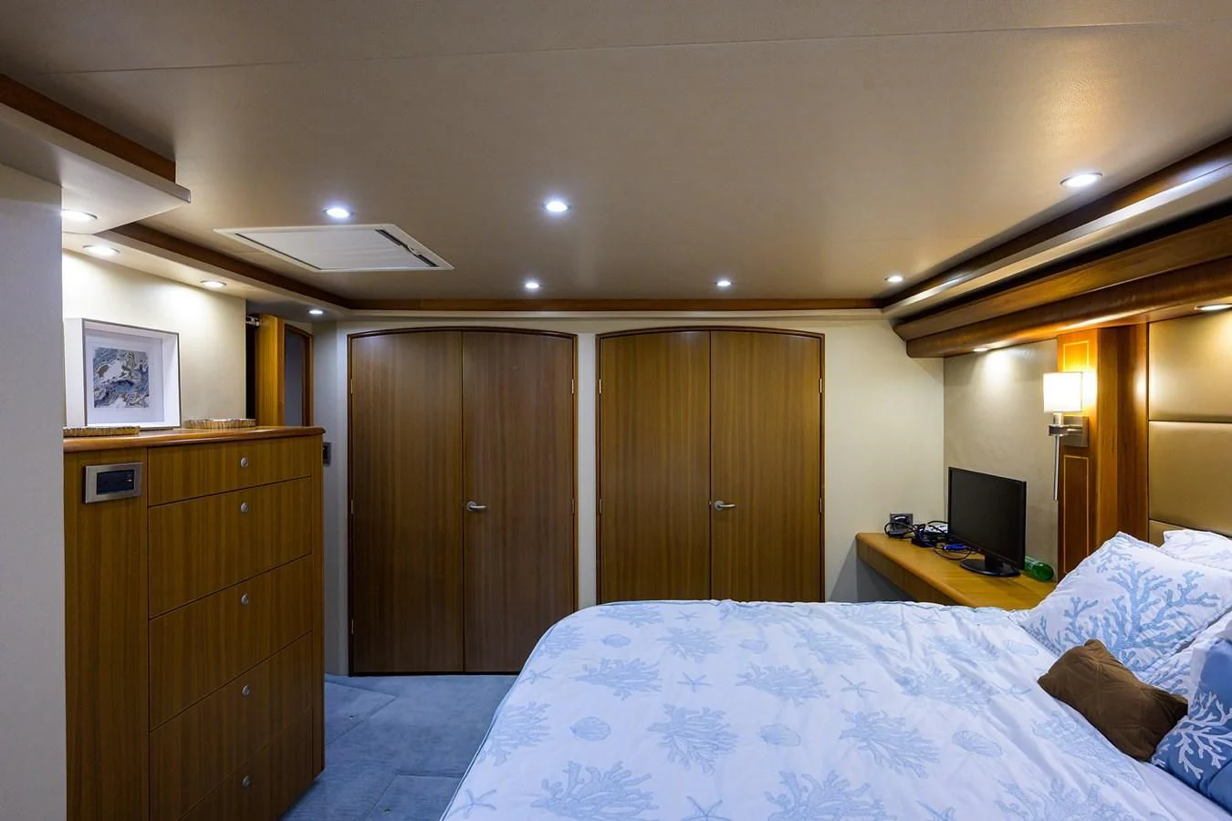 a bedroom with a bed and a television aboard RITE ANGLER Yacht for Sale