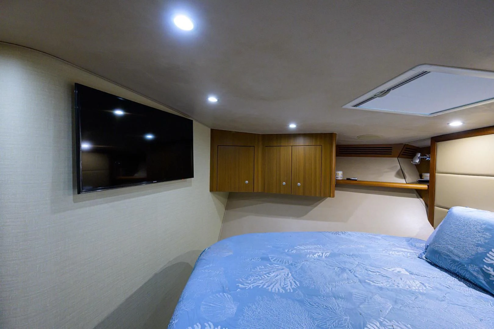 a bedroom with a tv on the wall aboard RITE ANGLER Yacht for Sale