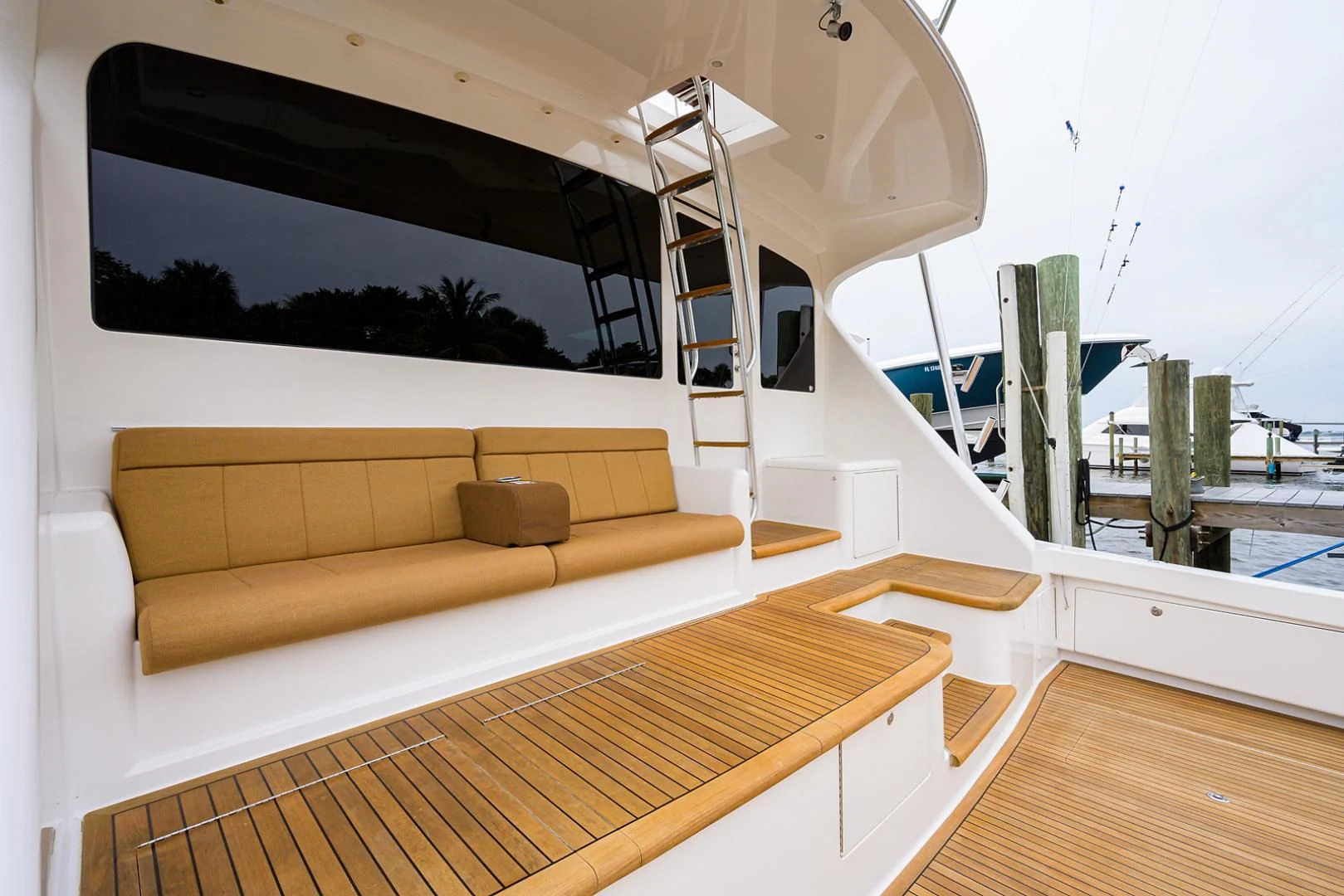 a room with a couch and a large window aboard RITE ANGLER Yacht for Sale