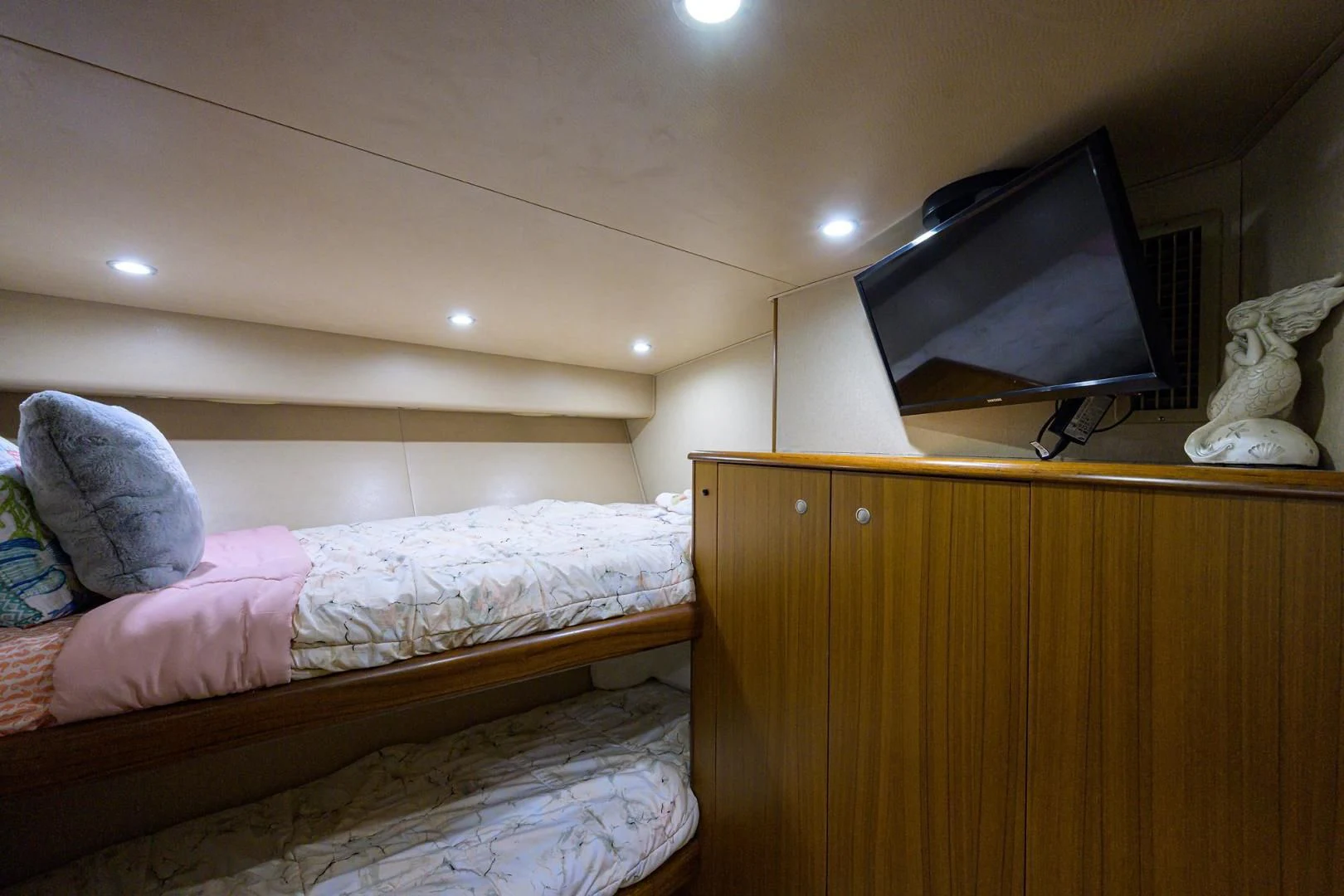 a bedroom with a bed and a tv on the wall aboard RITE ANGLER Yacht for Sale