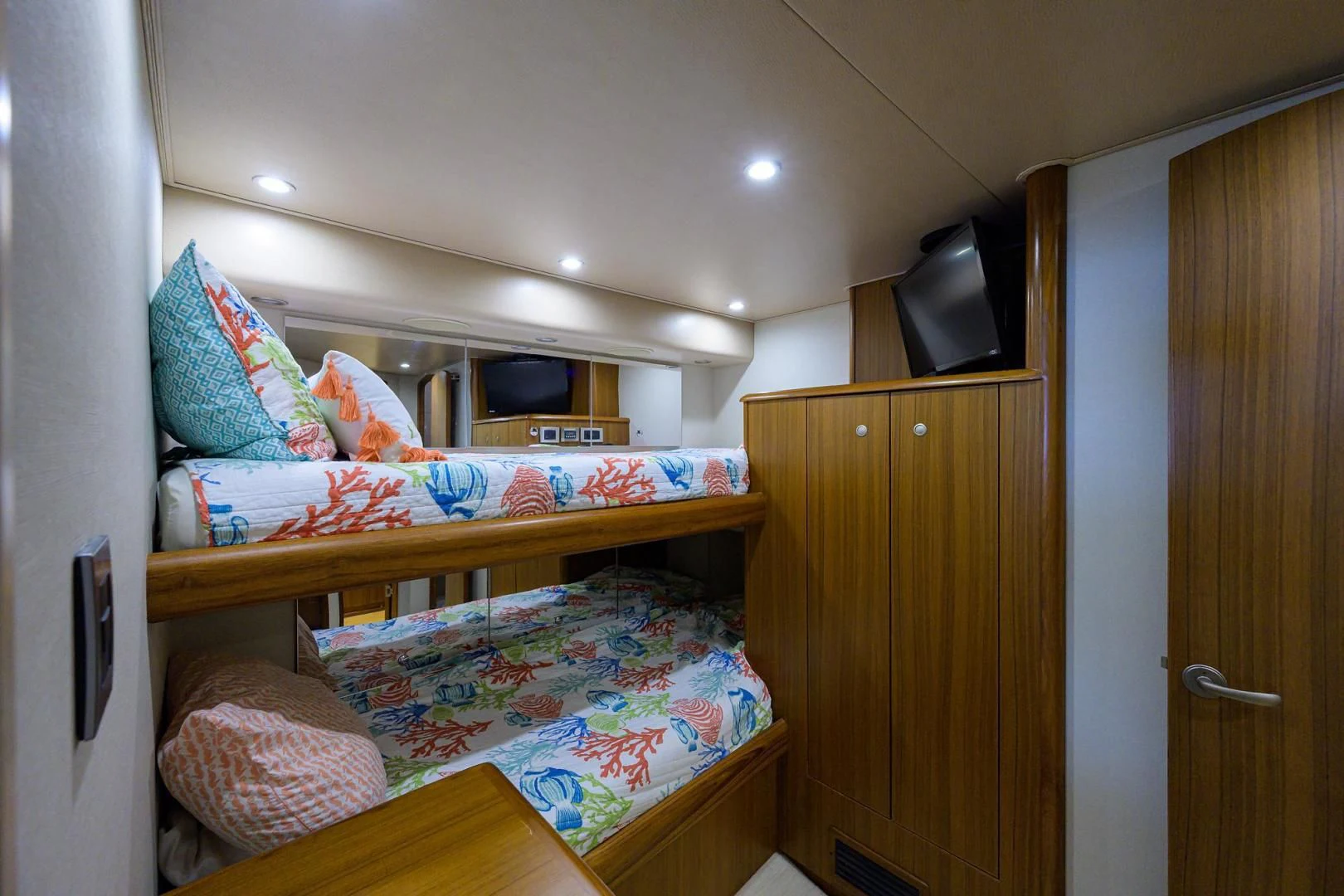 a bedroom with a bed and a television aboard RITE ANGLER Yacht for Sale