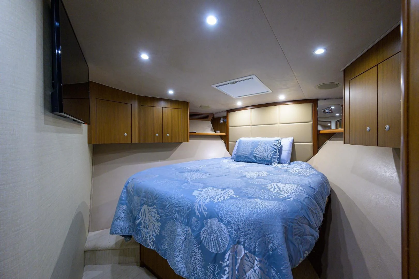 a room with a bed and cabinets aboard RITE ANGLER Yacht for Sale