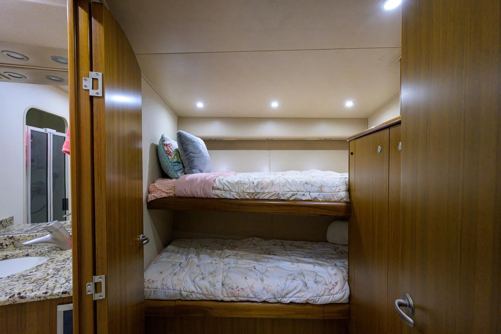 a room with a bed and a mirror aboard RITE ANGLER Yacht for Sale