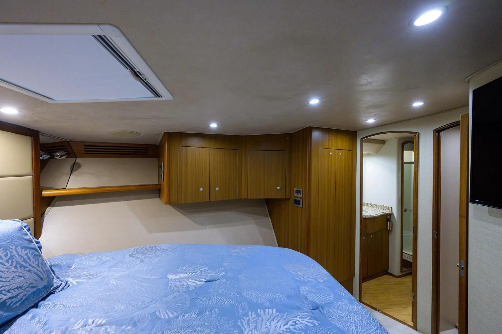 a bedroom with a bed and a closet aboard RITE ANGLER Yacht for Sale