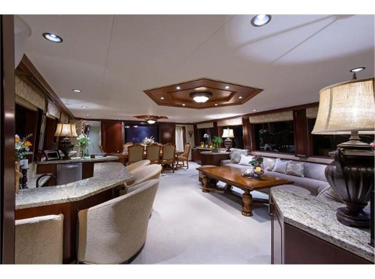 a large living room with a large chandelier aboard NO EXCEPTIONS Yacht for Sale