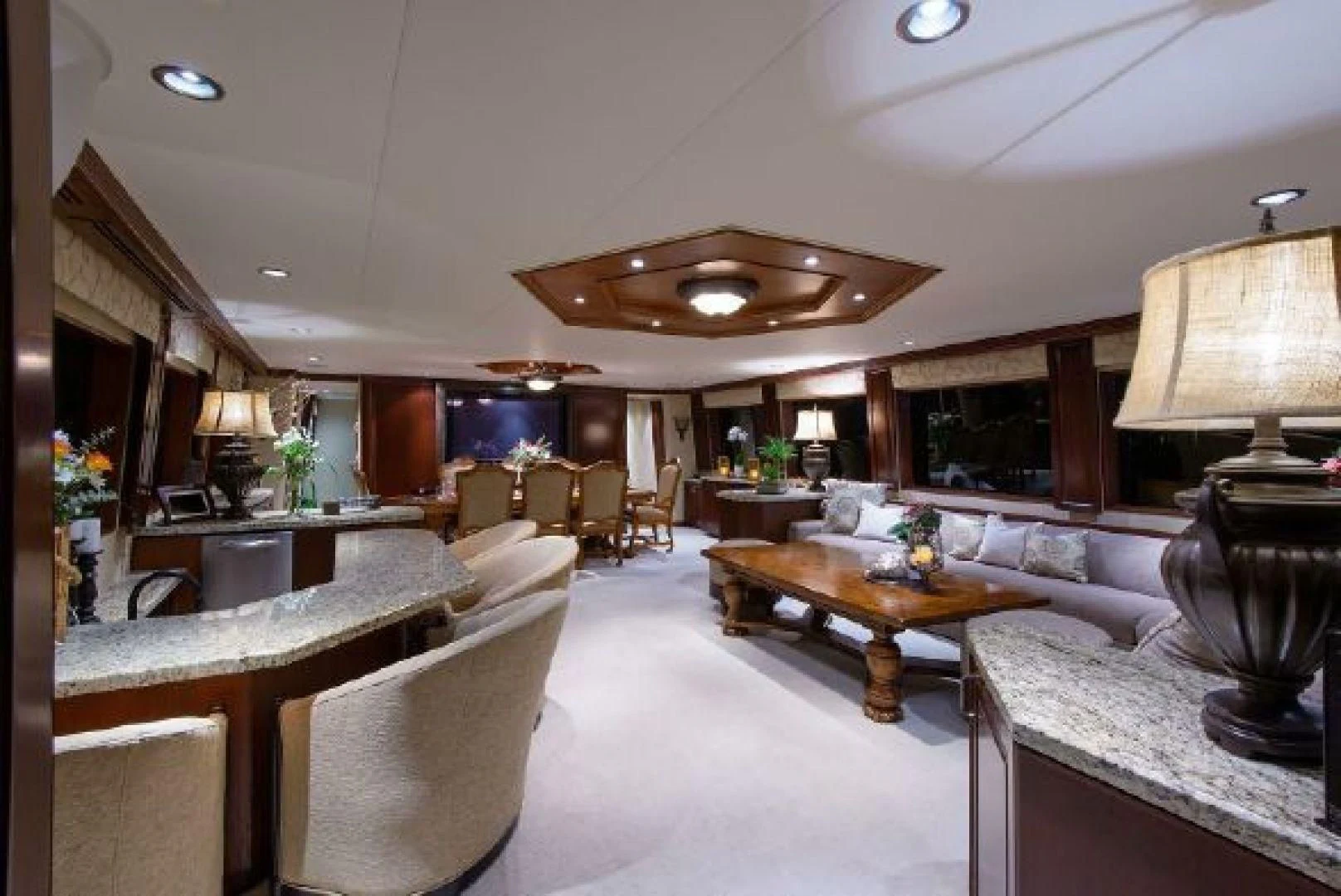 a living room with a large table and chairs aboard NO EXCEPTIONS Yacht for Sale