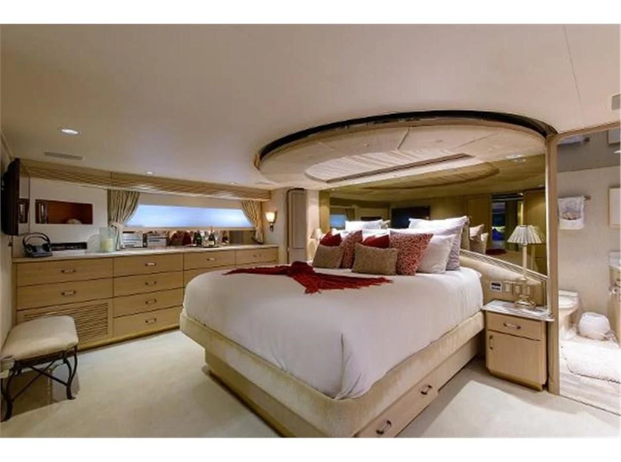 a bedroom with a bed and a mirror aboard NO EXCEPTIONS Yacht for Sale