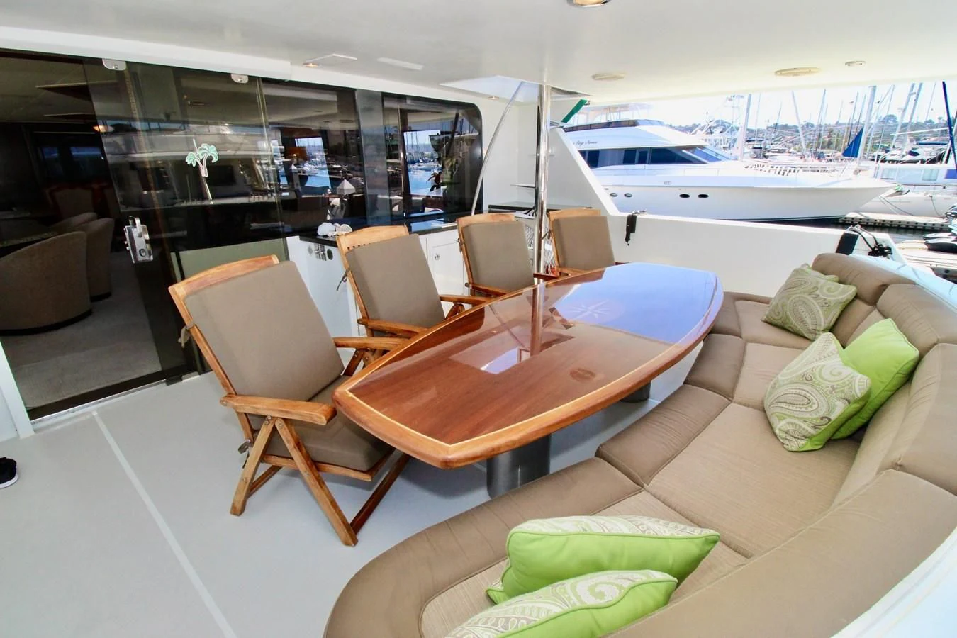 a room with a table chairs and a boat in the background aboard NO EXCEPTIONS Yacht for Sale