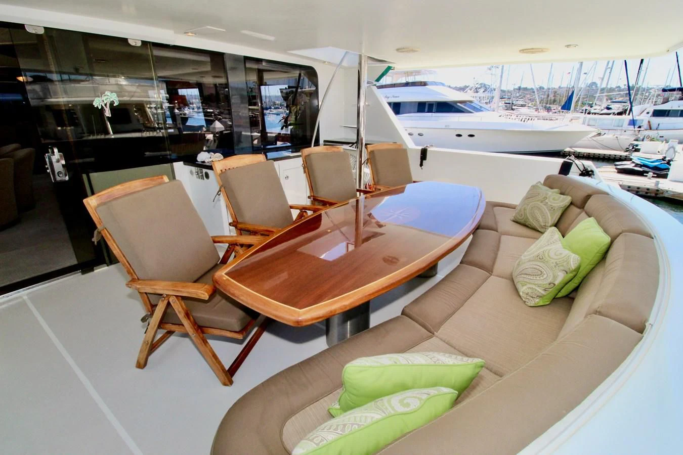 a room with a table chairs and a boat in the background aboard NO EXCEPTIONS Yacht for Sale
