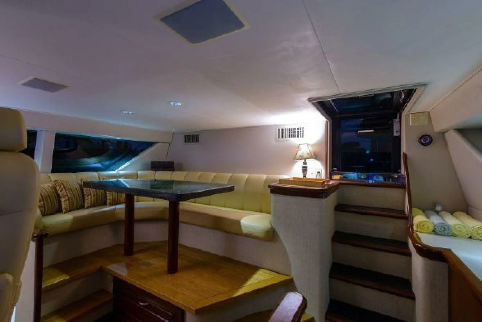 a living room with a table and couches aboard NO EXCEPTIONS Yacht for Sale