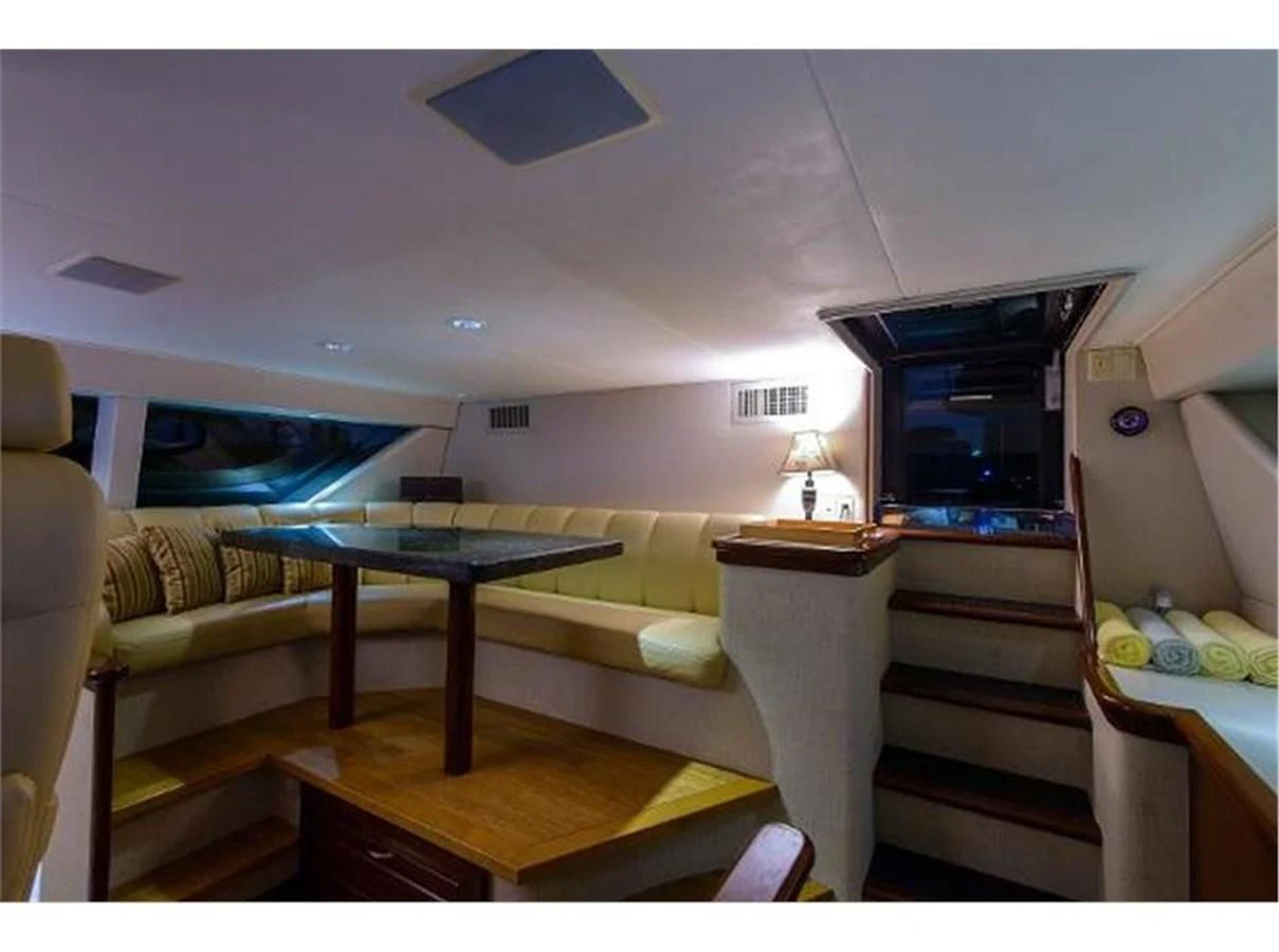 a bedroom with a bed and a table aboard NO EXCEPTIONS Yacht for Sale