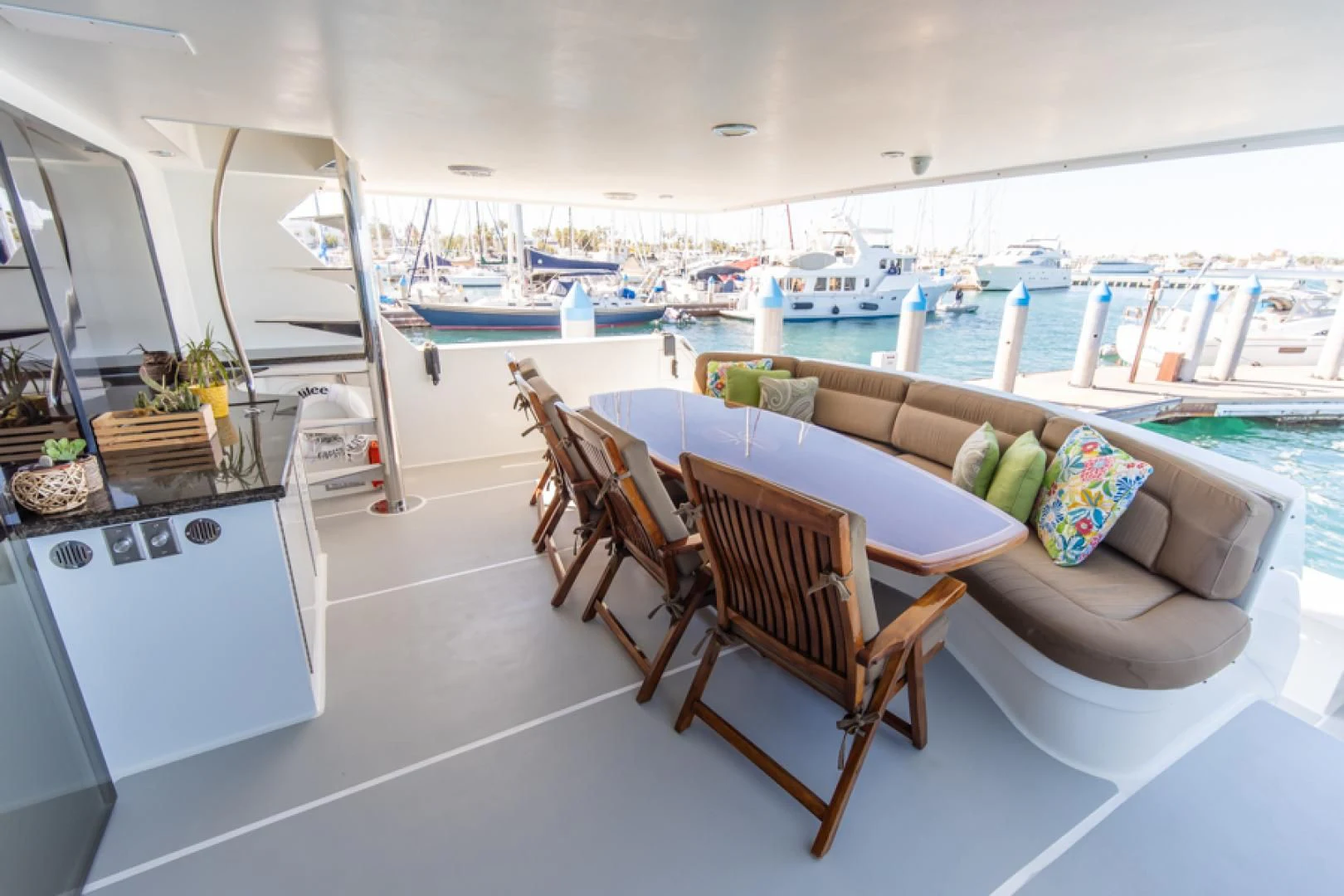 a room with a table chairs and a view of the water aboard NO EXCEPTIONS Yacht for Sale