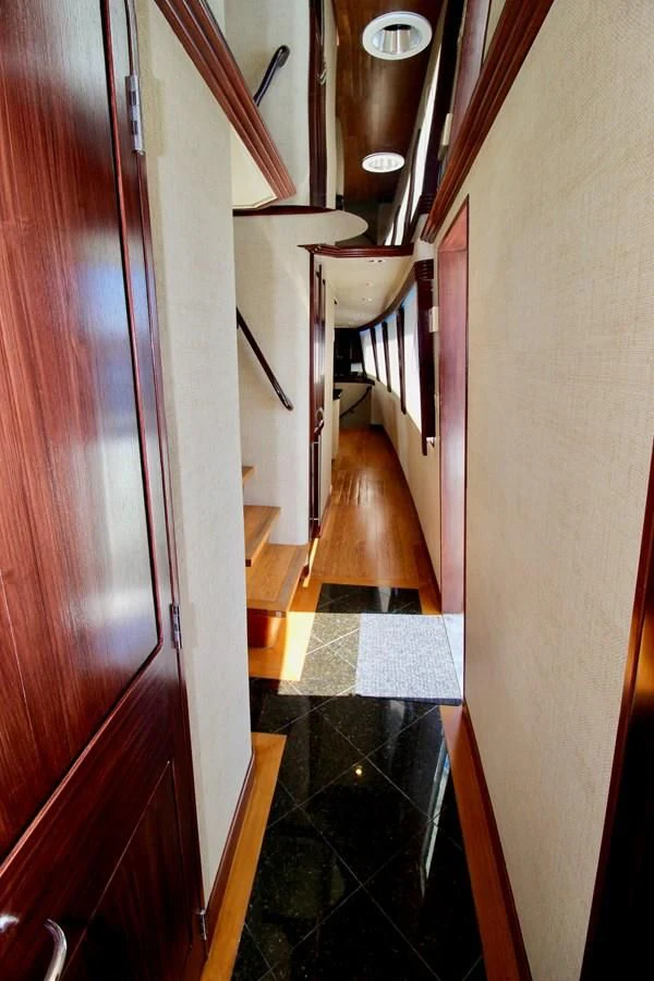 a hallway with a tile floor and a wood door aboard NO EXCEPTIONS Yacht for Sale