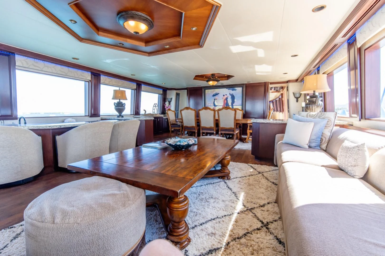 a living room with a table and couches aboard NO EXCEPTIONS Yacht for Sale