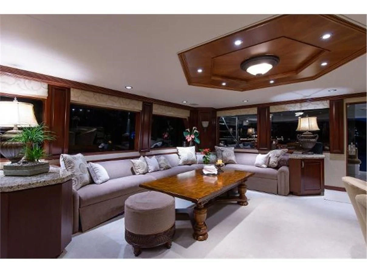 a living room with a large fireplace aboard NO EXCEPTIONS Yacht for Sale