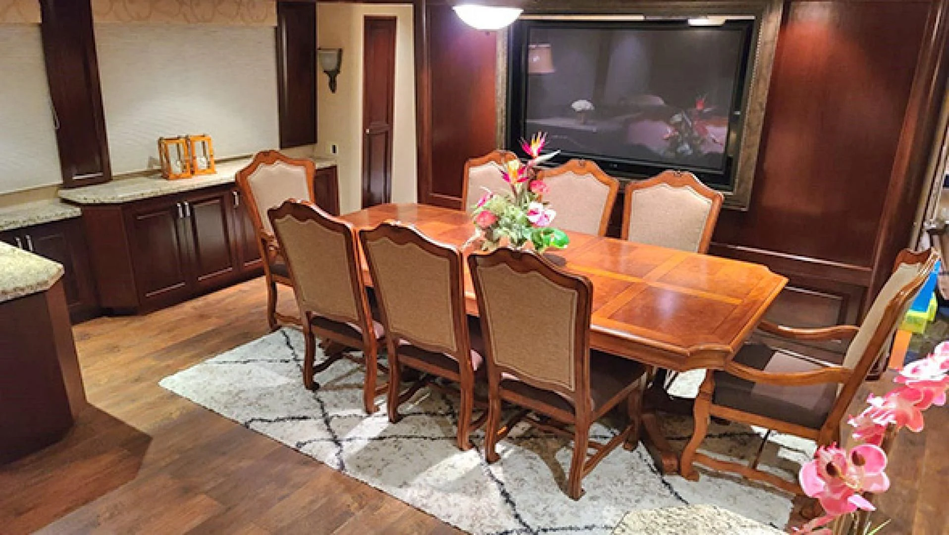 a dining table with chairs and a television in the background aboard NO EXCEPTIONS Yacht for Sale
