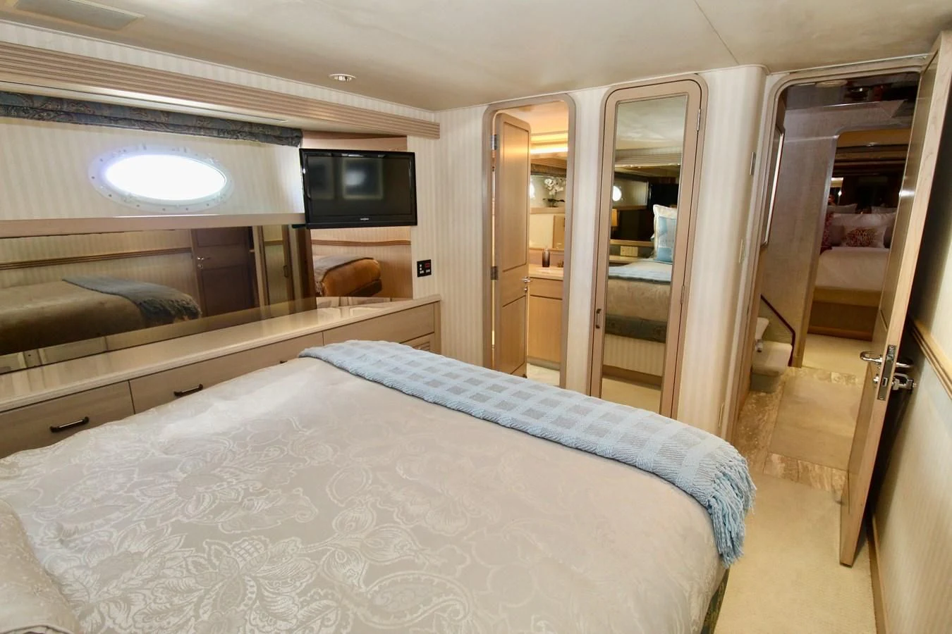 a bedroom with a bed and a television aboard NO EXCEPTIONS Yacht for Sale