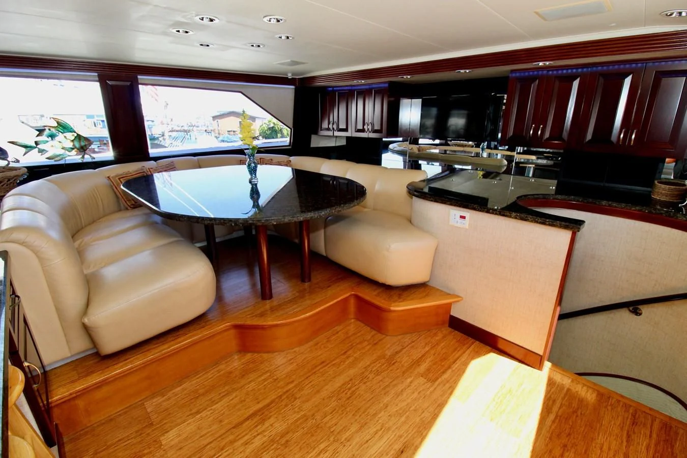 a living room with a table and couches aboard NO EXCEPTIONS Yacht for Sale