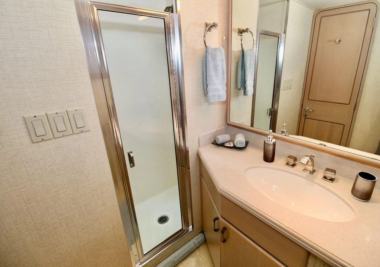 a bathroom with a large mirror aboard NO EXCEPTIONS Yacht for Sale