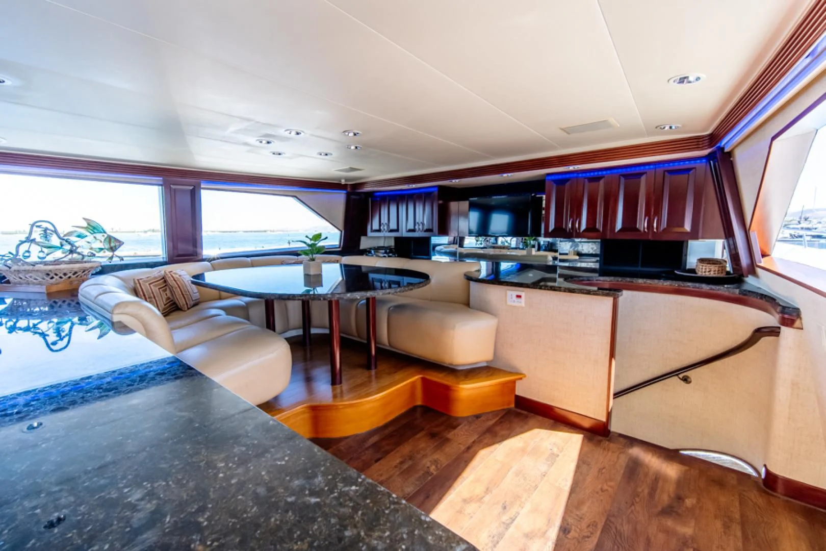 a room with a table and couch aboard NO EXCEPTIONS Yacht for Sale