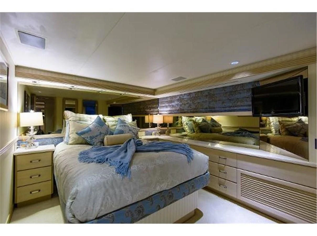 a bedroom with a bed and a dresser aboard NO EXCEPTIONS Yacht for Sale