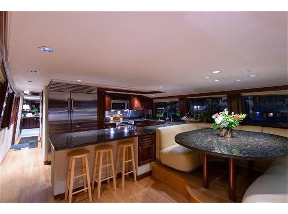 a kitchen with a table and chairs aboard NO EXCEPTIONS Yacht for Sale