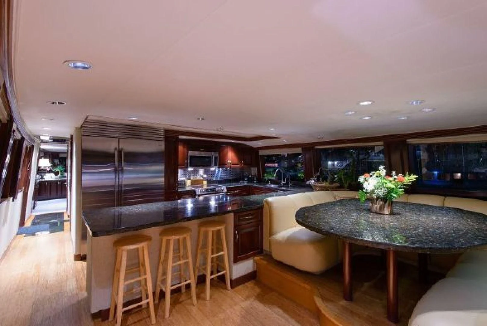 a kitchen with a bar and a table aboard NO EXCEPTIONS Yacht for Sale
