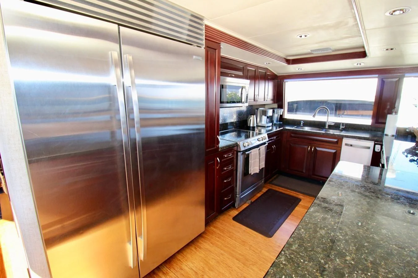 a large stainless steel refrigerator in a kitchen aboard NO EXCEPTIONS Yacht for Sale