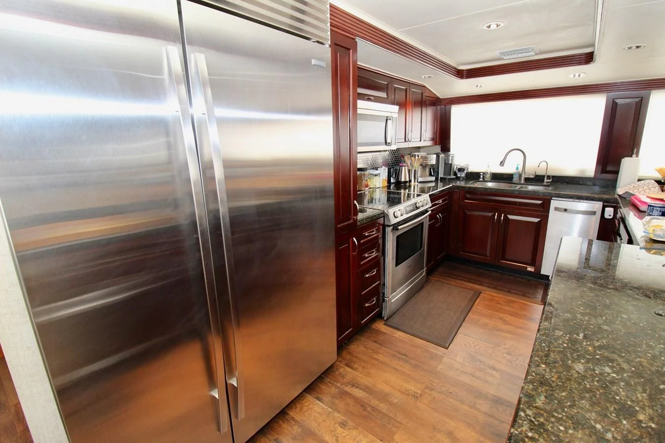 a large stainless steel refrigerator in a kitchen aboard NO EXCEPTIONS Yacht for Sale