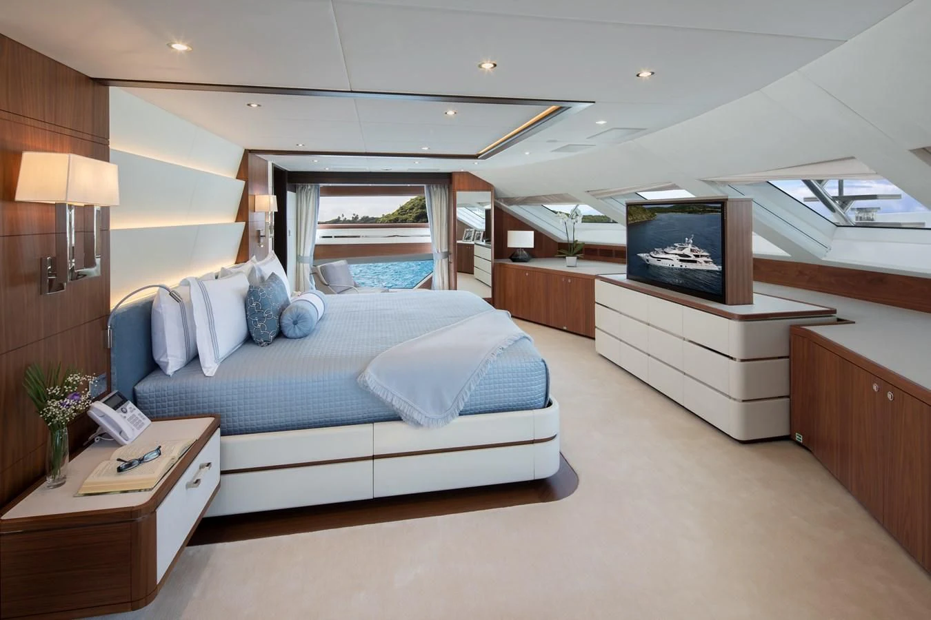 a bedroom with a bed and a tv aboard JODI ANN Yacht for Charter