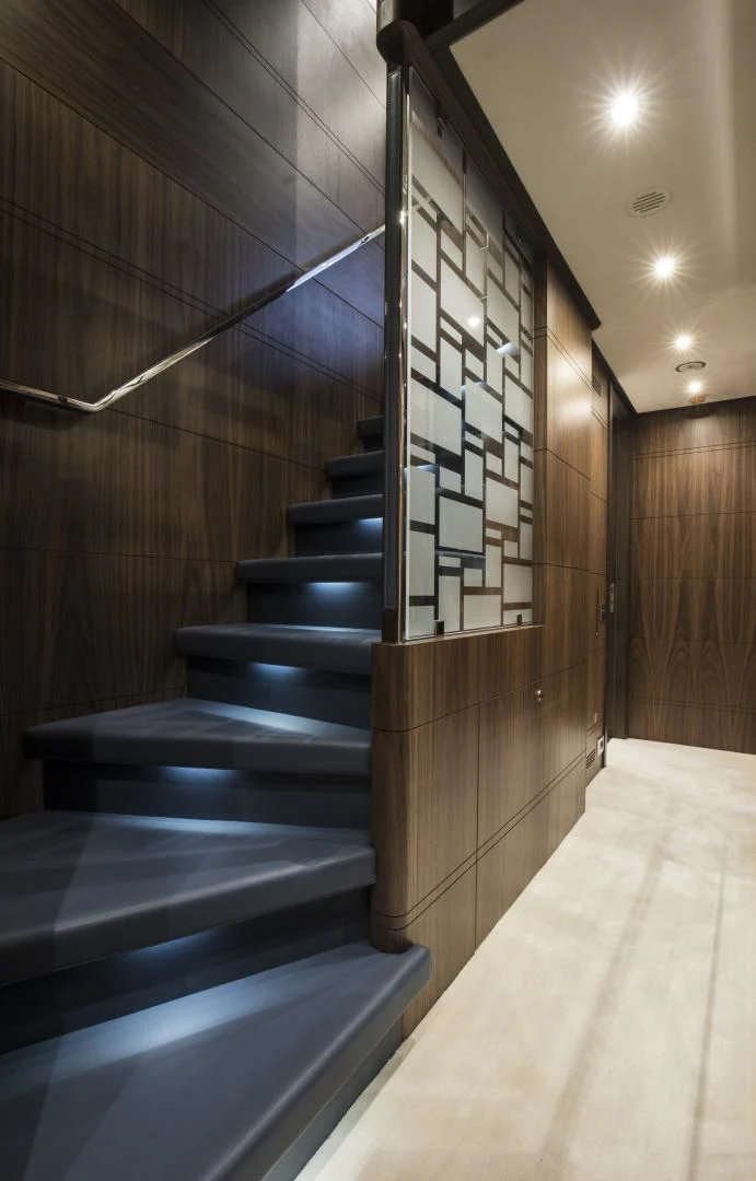 a wood staircase with a wood railing aboard JODI ANN Yacht for Charter