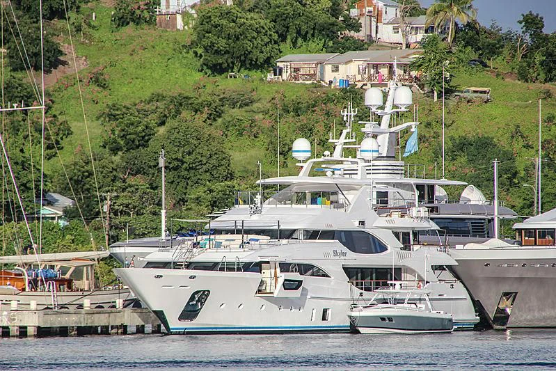 a large white boat sits at a dock aboard JODI ANN Yacht for Charter