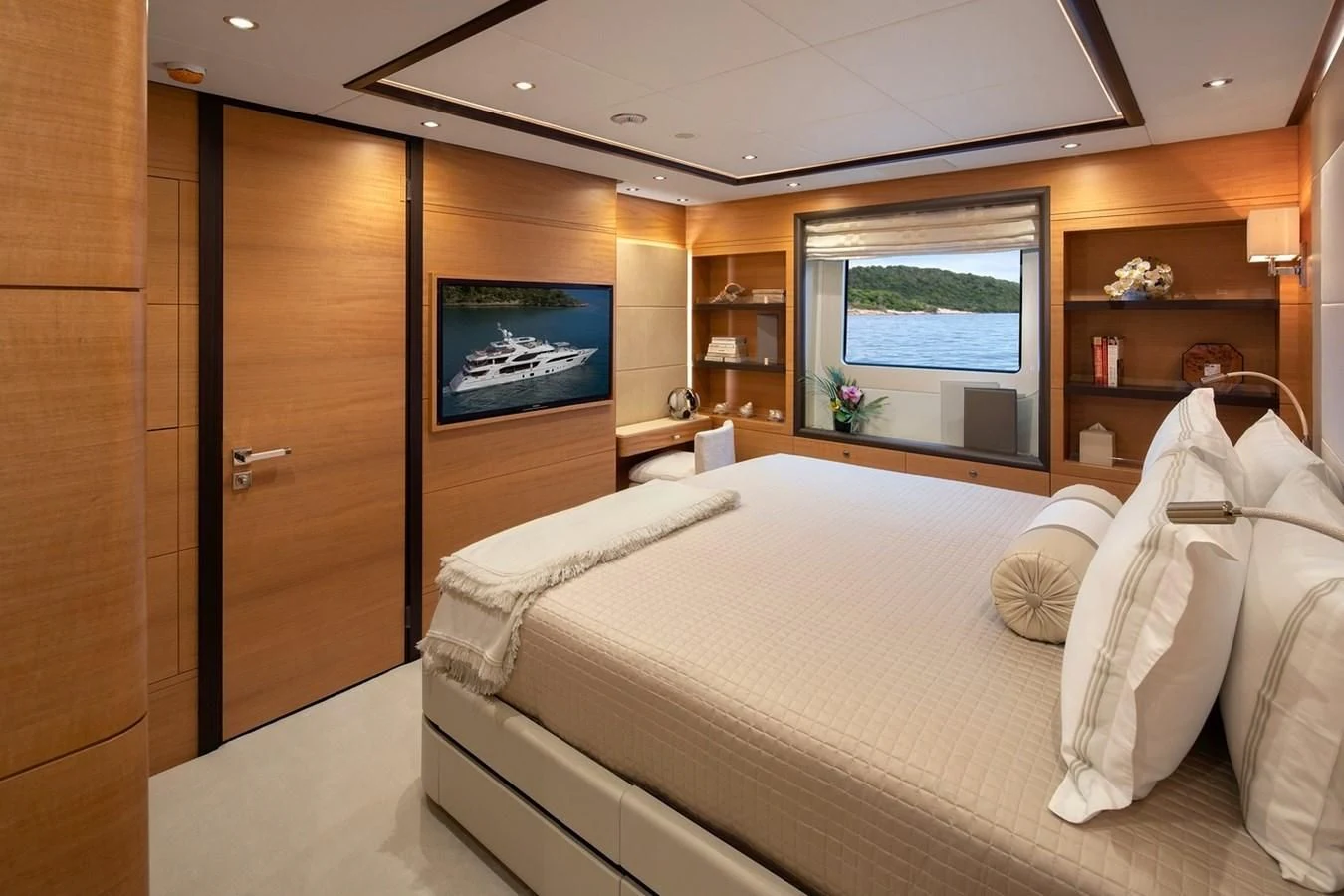 a room with a bed and a television aboard JODI ANN Yacht for Charter