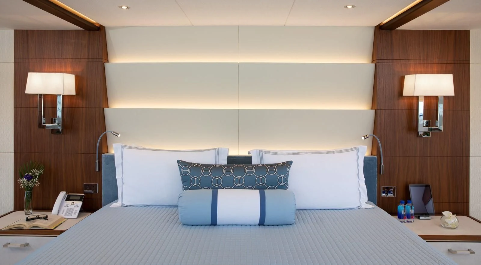 a bed with a blue and white bed spread aboard JODI ANN Yacht for Charter