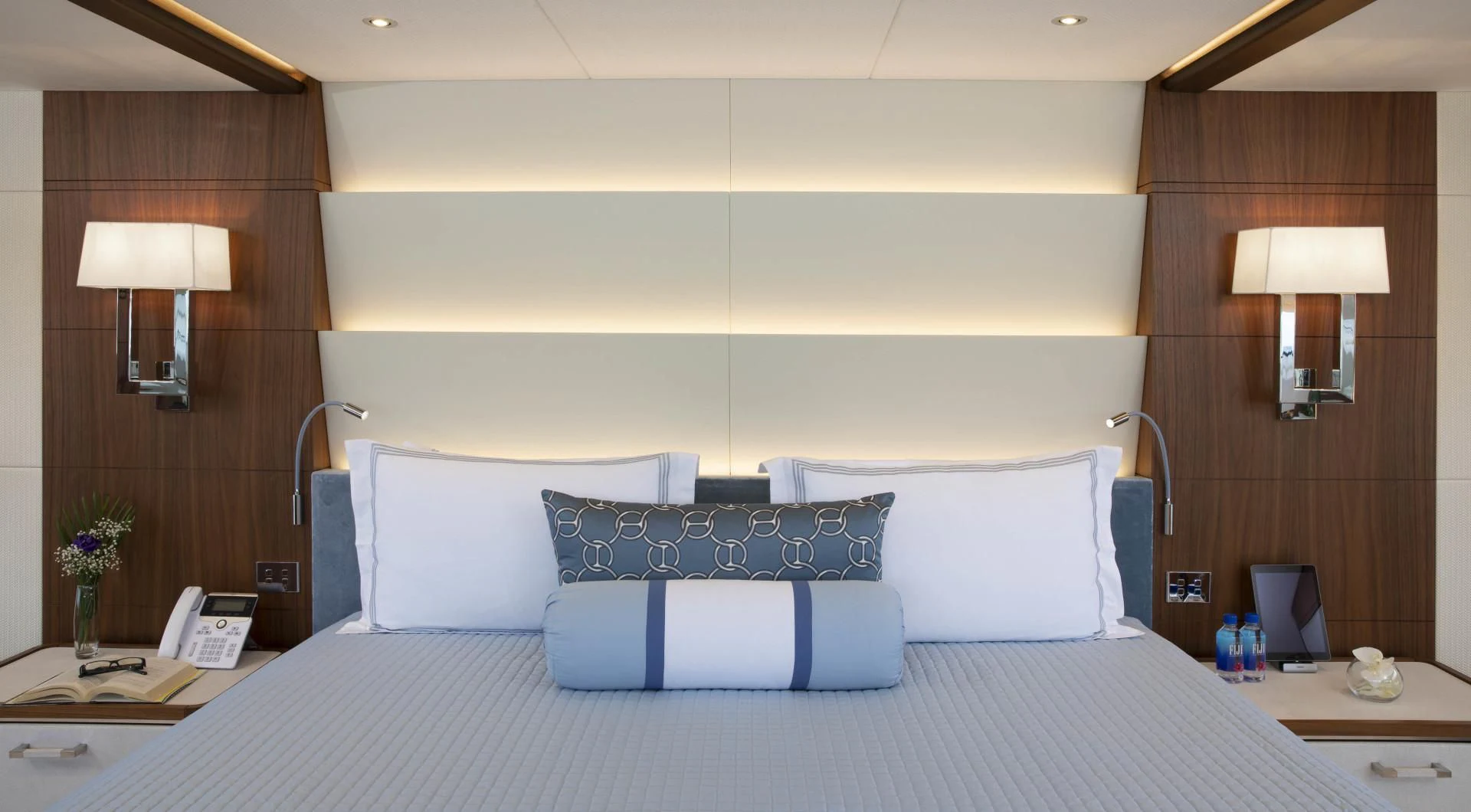 a bed with a blue and white bed spread aboard JODI ANN Yacht for Charter