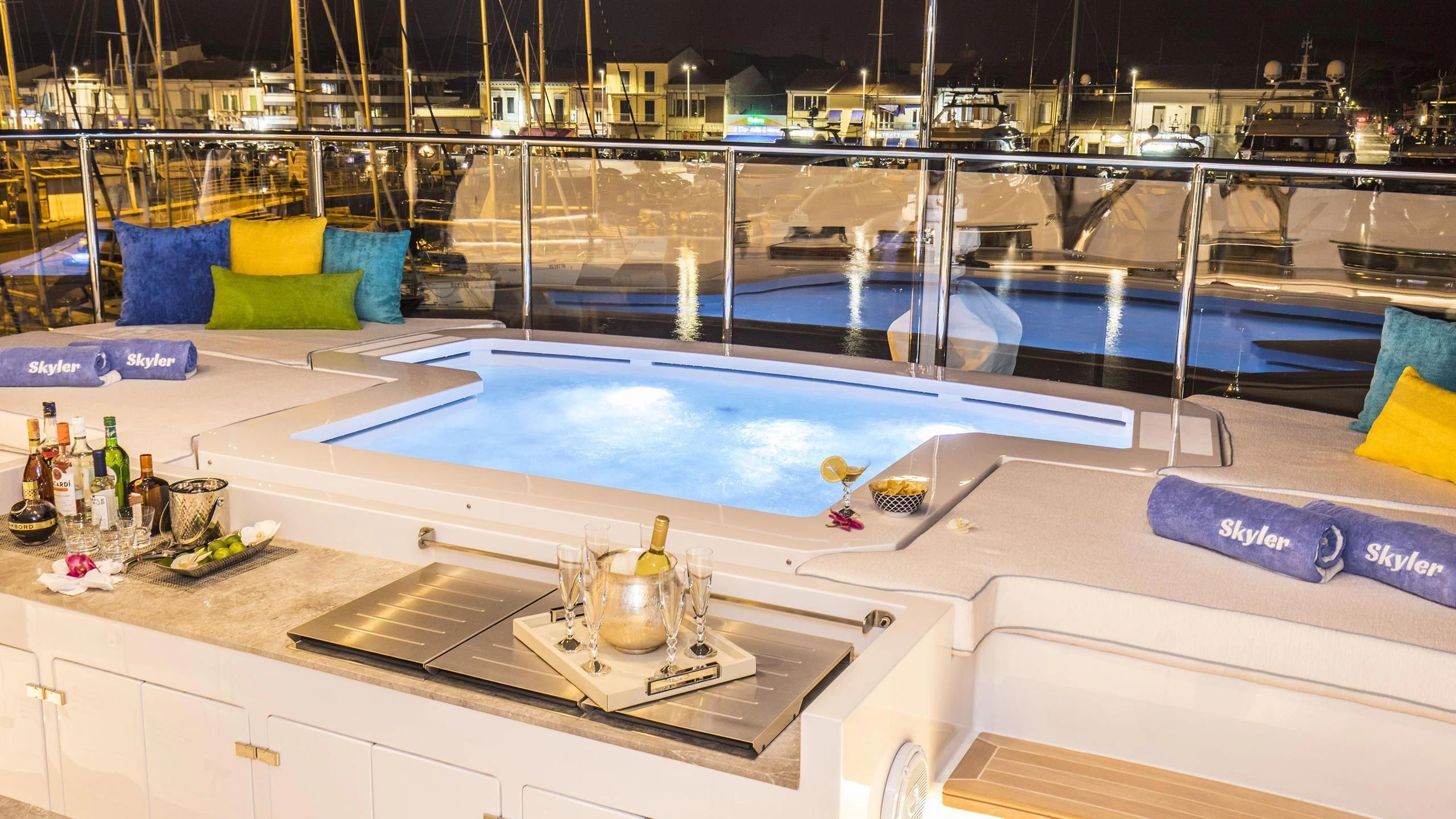a large pool with a table and chairs and a table with a large window aboard JODI ANN Yacht for Charter