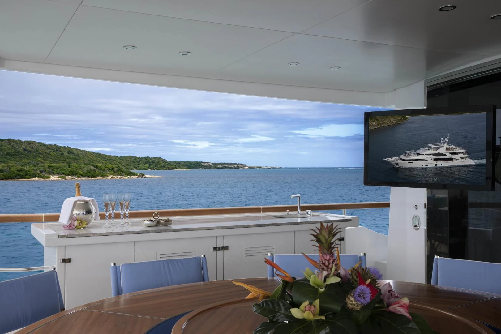 a room with a table and chairs and a large body of water aboard JODI ANN Yacht for Charter