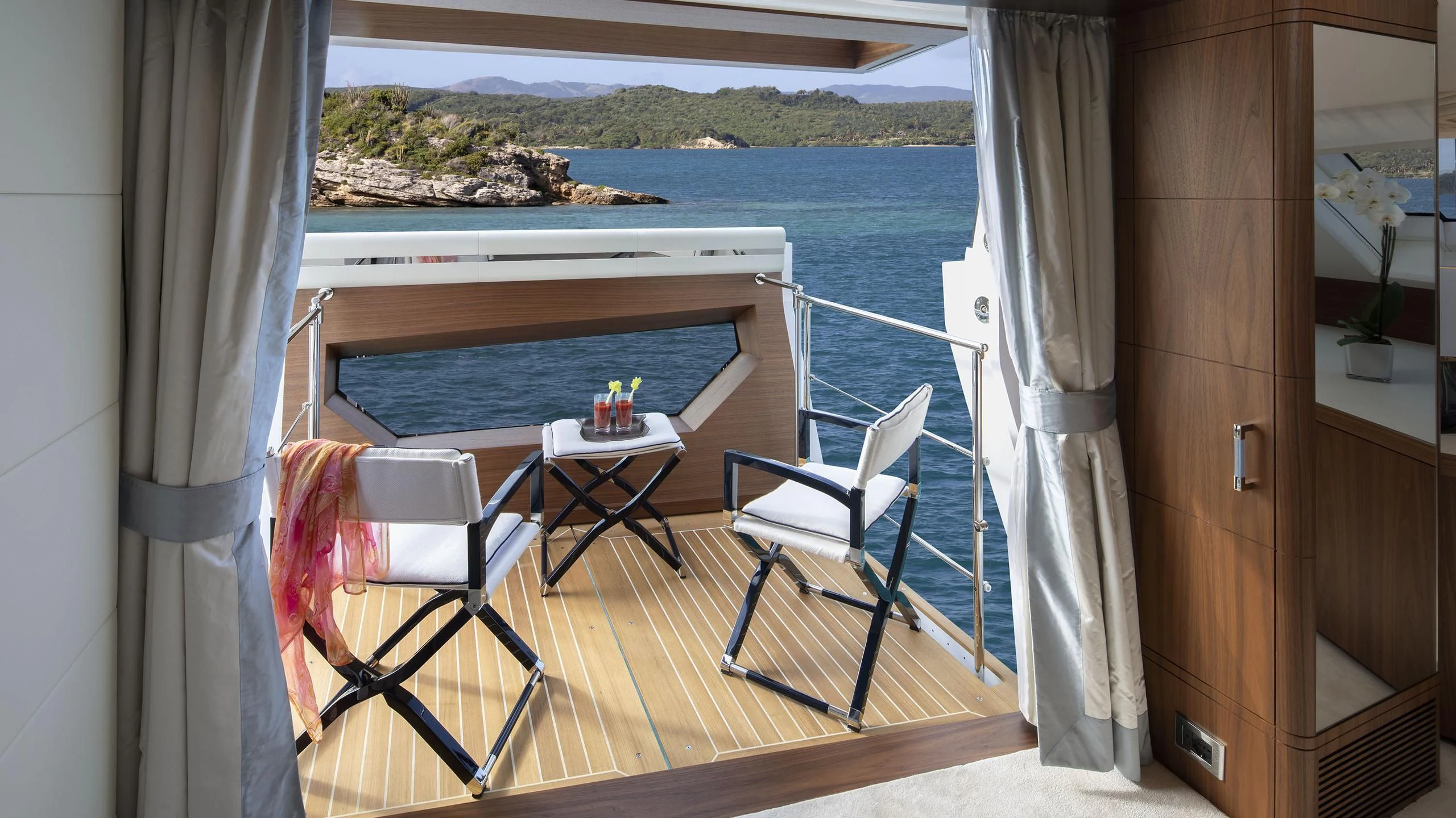a balcony with a table and chairs aboard JODI ANN Yacht for Charter