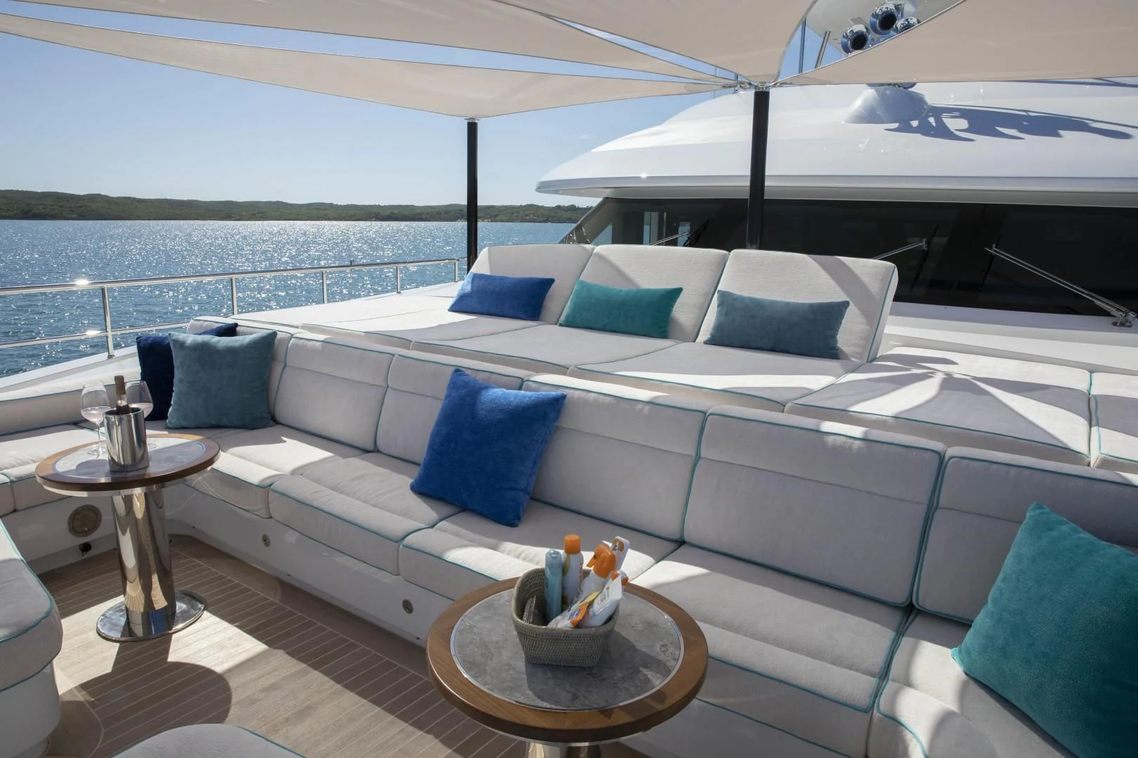 a couch with pillows and a table on it aboard JODI ANN Yacht for Charter