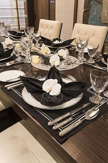 a table with plates and silverware aboard JODI ANN Yacht for Charter