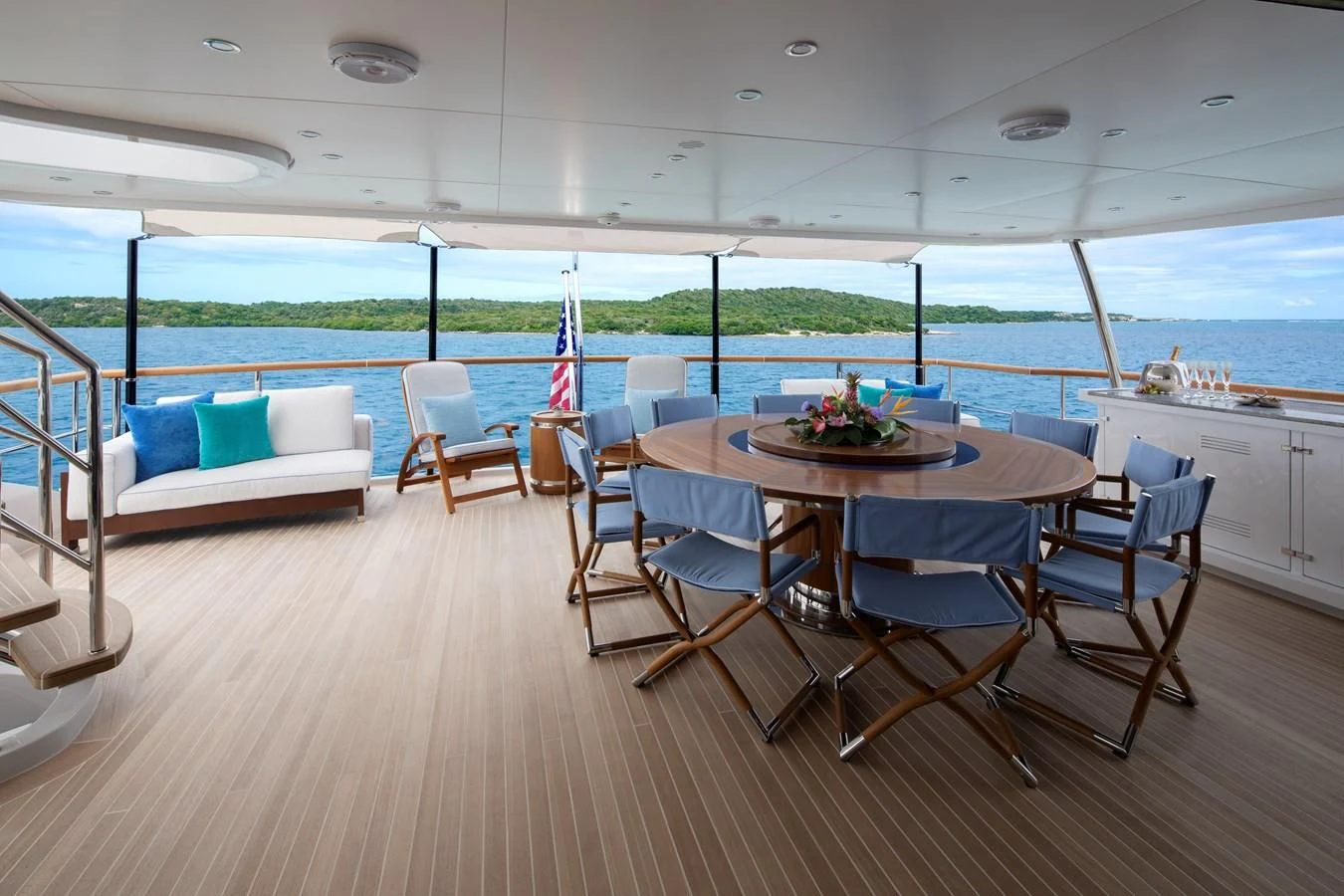 a large room with a table and chairs and a view of the ocean aboard JODI ANN Yacht for Charter