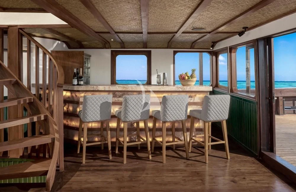 a room with a table chairs and a tv aboard SAMSARA SAMUDRA Yacht for Sale