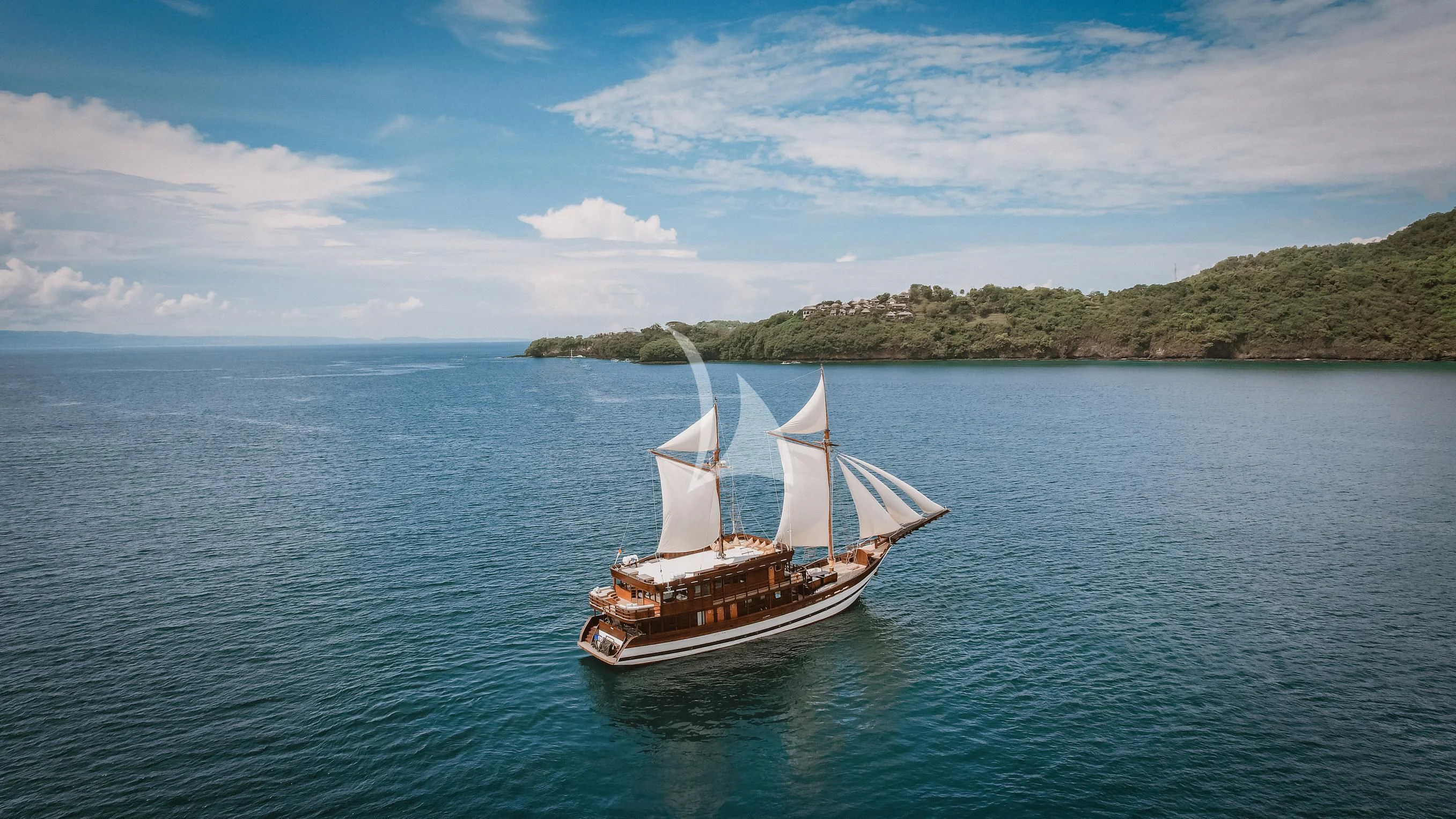 a small sailboat on the water aboard SAMSARA SAMUDRA Yacht for Sale