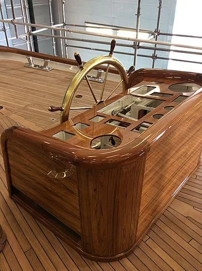 a wooden wheel with a large wooden wheel aboard VAGRANT Yacht for Sale