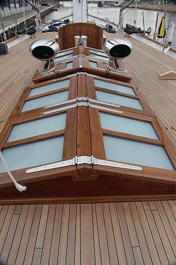 a wooden boat in a harbor aboard VAGRANT Yacht for Sale